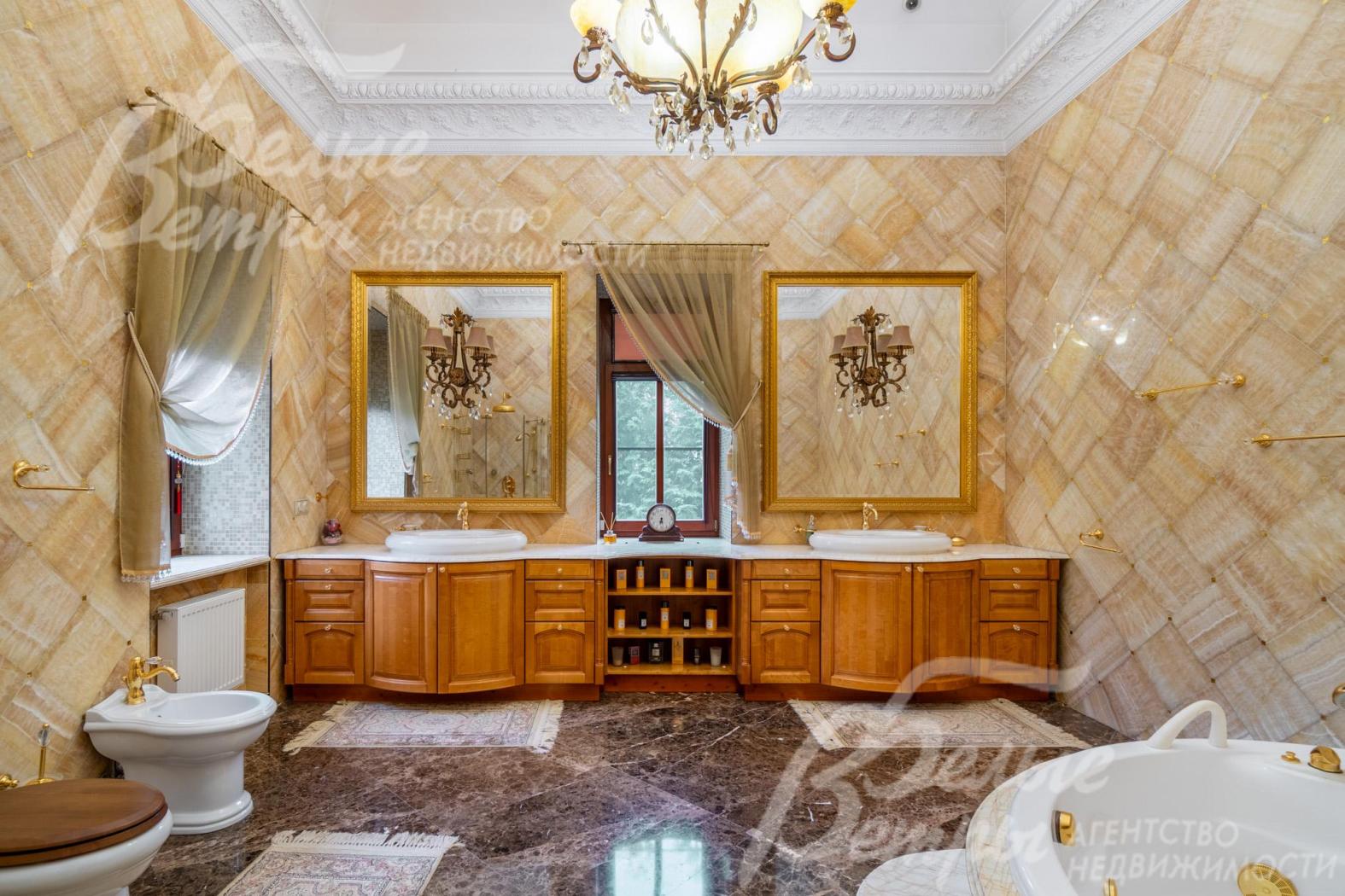 Санузел при мастер-спальне 25 кв.м с элитной сантехникой и мебелью, стены отделаны ониксом