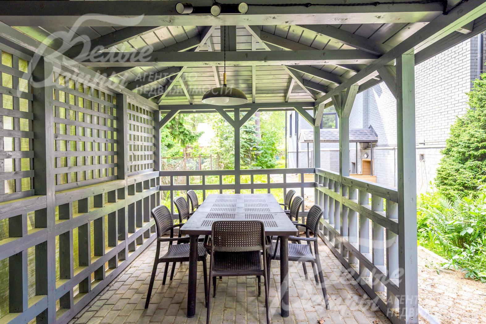 В беседке установлен большой стол на 8 персон