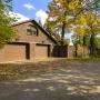 Один из гаражей на участке со въездом со стороны дороги. Въезд оборудован автоматическими воротами. На втором этаже - квартира для персонала