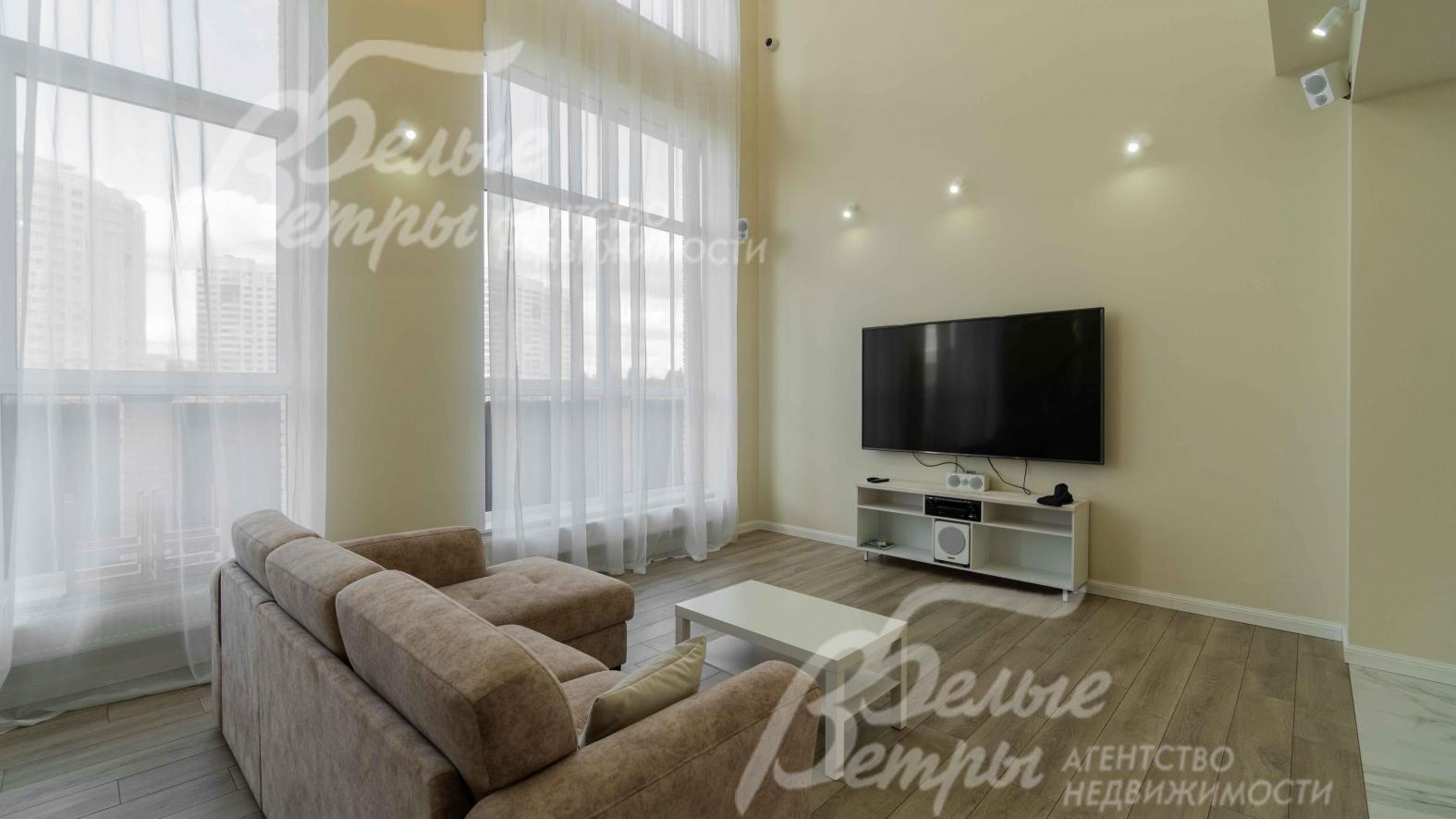 В гостиной есть ТВ и диван