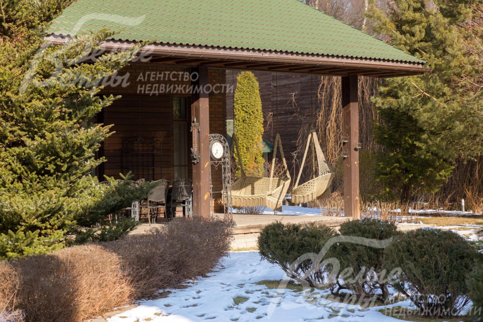 На участке – эффектный парковый ландшафт по индивидуальному дизайн-проекту, дорожки выложены из камня и плитки, выполнено освещение, засеян газон, высажены разнообразные деревья, цветы и кустарники