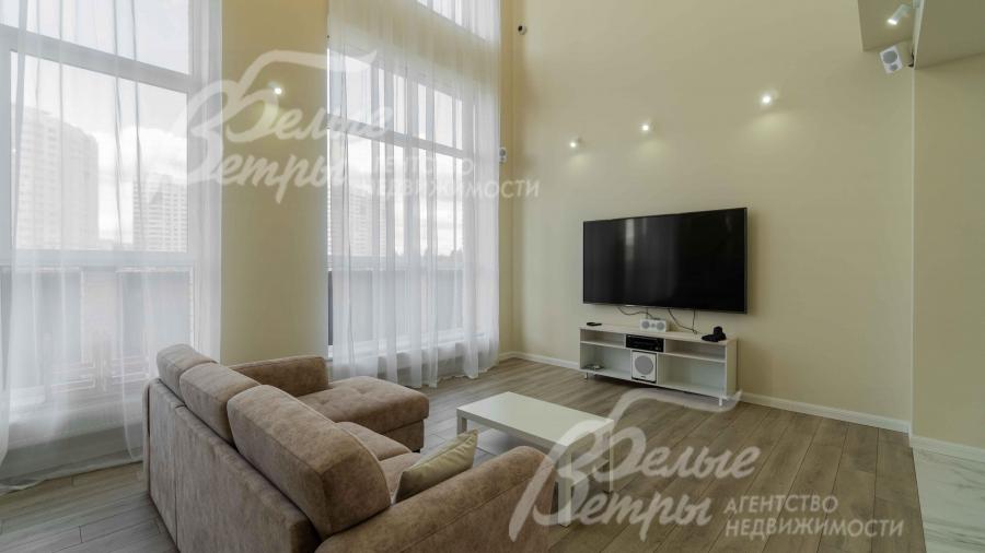 В гостиной есть ТВ и диван