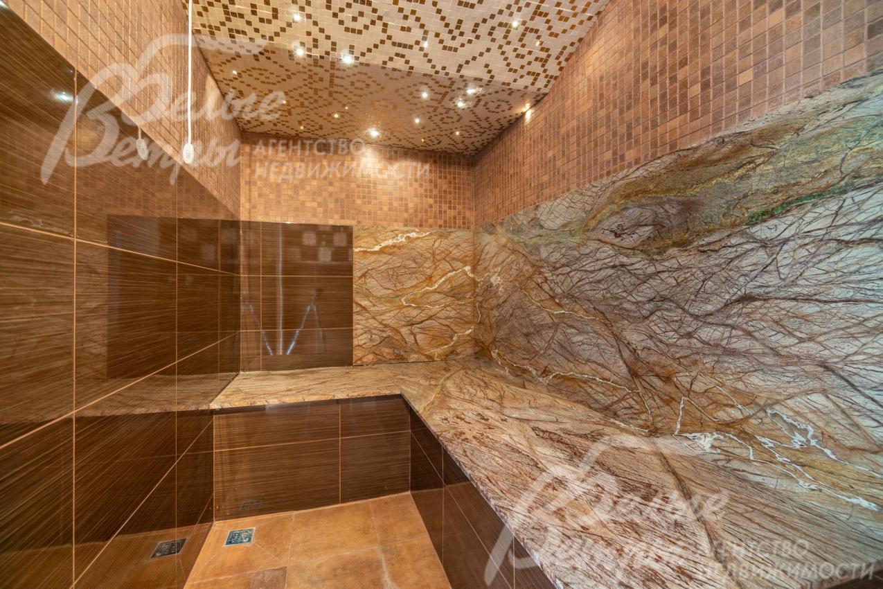 На первом этаже дома есть хамам с коричневыми оттенками в отделке