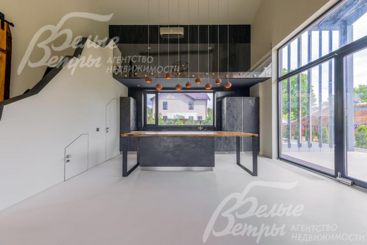 Панорамные раздвижные окна в пол в кухне-столовой.