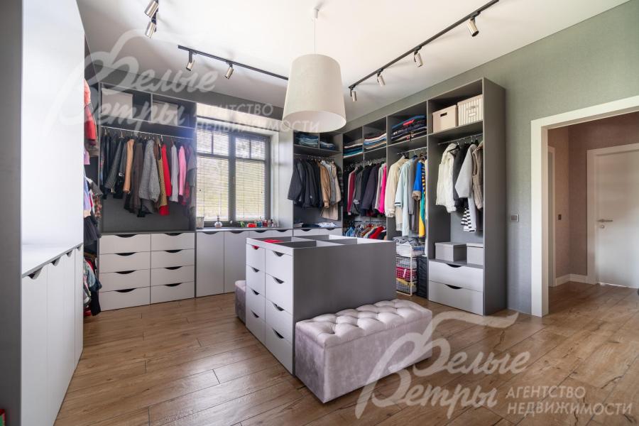 На первом этаже есть просторная светлая гардеробная 20 кв.м, оснащённая удобной системой хранения