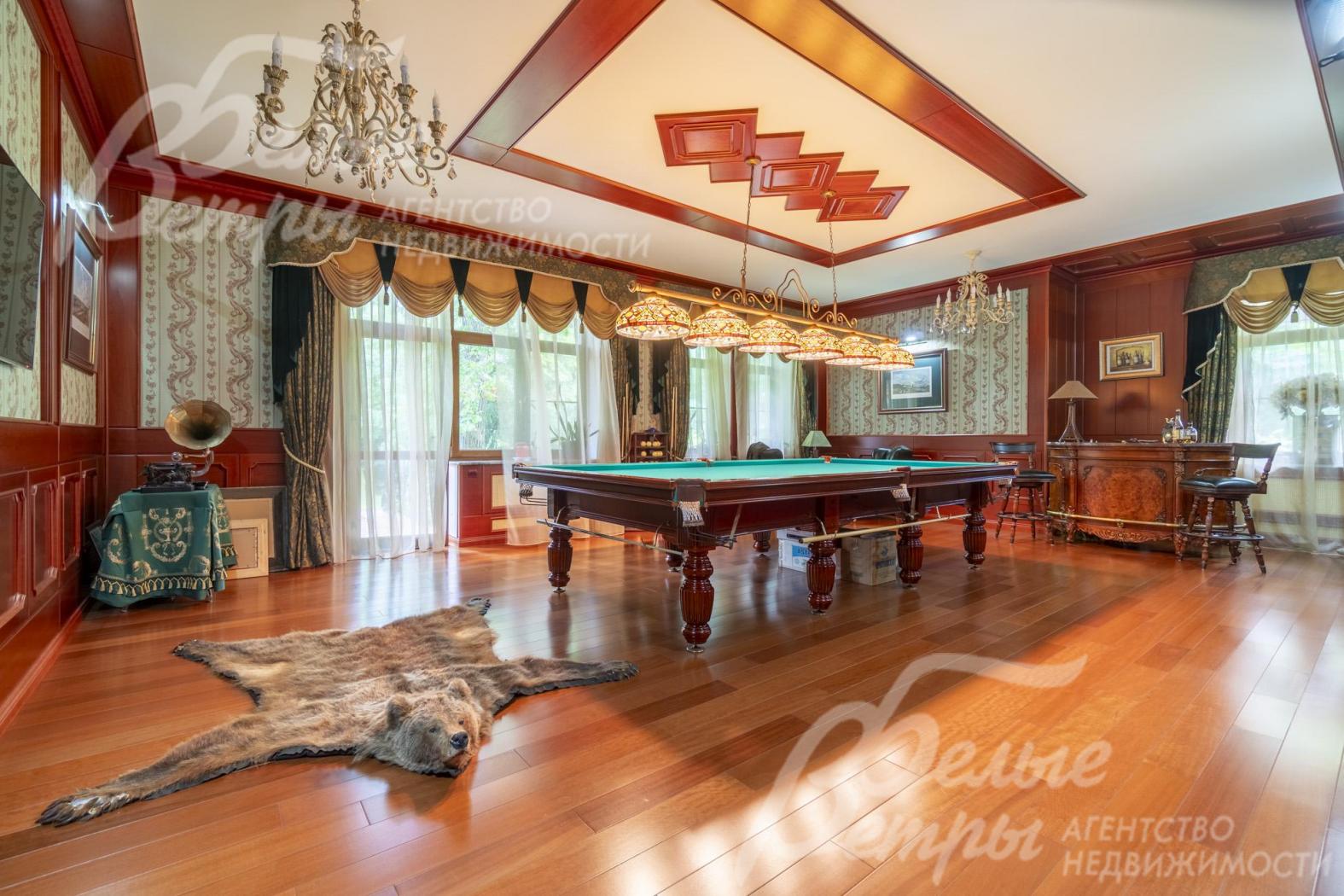 Просторная бильярдная на первом этаже с широкой площадью остекления