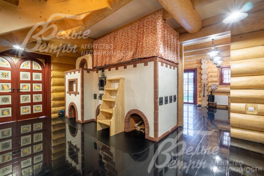 Центральный элемент в холле и кухне-столовой – кирпичная русская печь ручной работы: на печи - просторная лежанка размером с двуспальную кровать и специальная лестница для подъёма